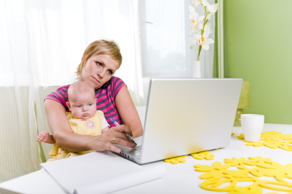 Woman on computer with baby